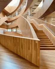 brown wooden spiral staircase with brown wooden railings