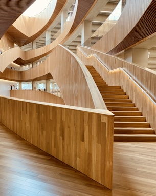 brown wooden spiral staircase with brown wooden railings
