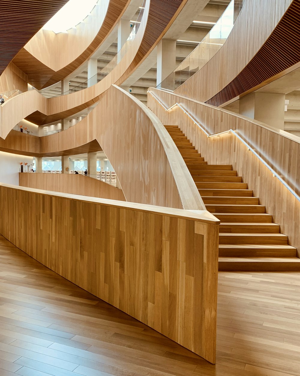 brown wooden spiral staircase with brown wooden railings