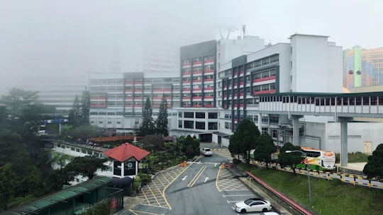 cars parked in front of white and red concrete building during daytime in Theme Park Hotel Malaysia