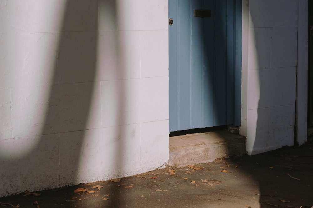 white concrete wall near black wooden door