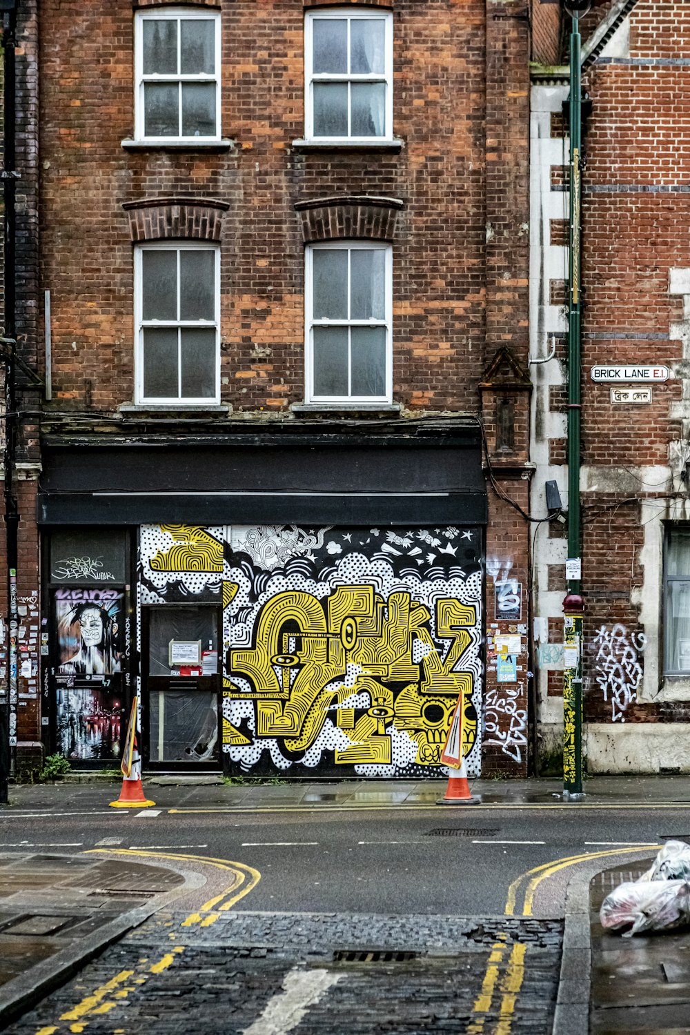 brown brick building with graffiti