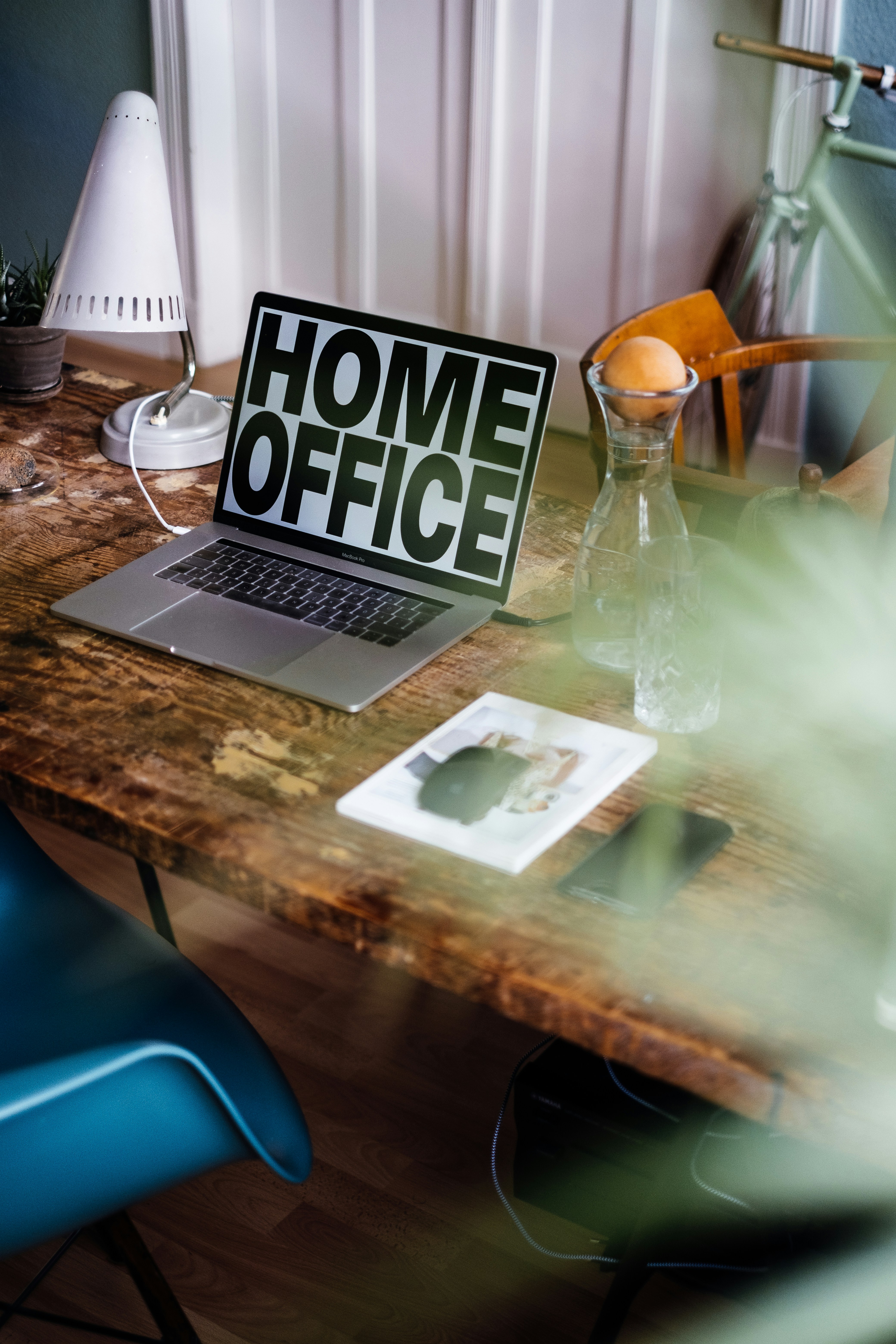 Modern laptop displaying home office text on a rustic wooden desk.
