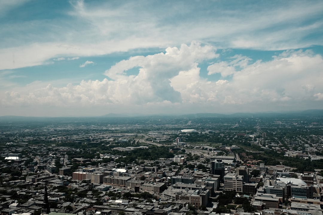 aerial view of city buildings under cloudy sky during daytime
