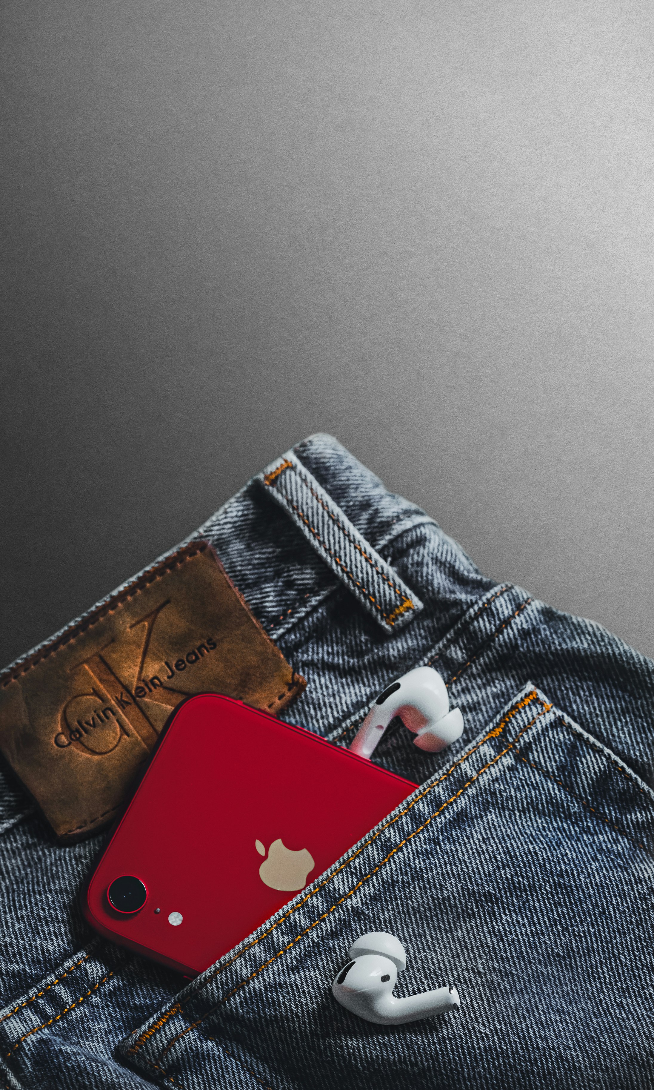 red and white card on blue denim jeans