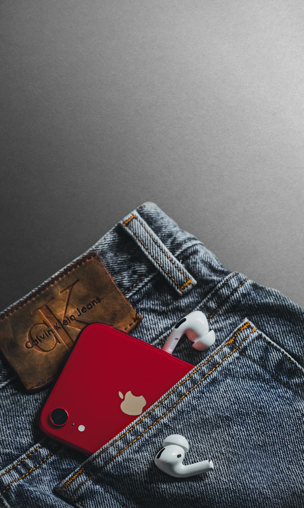 red and white card on blue denim jeans