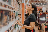 woman in black shirt standing near glass wall