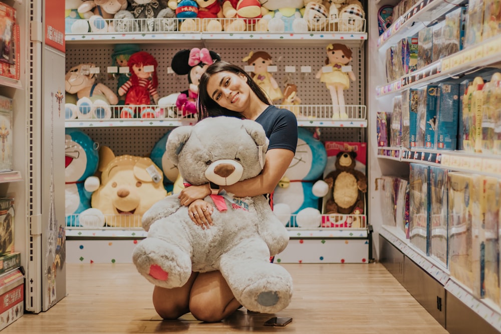 girl hugging brown bear plush toy
