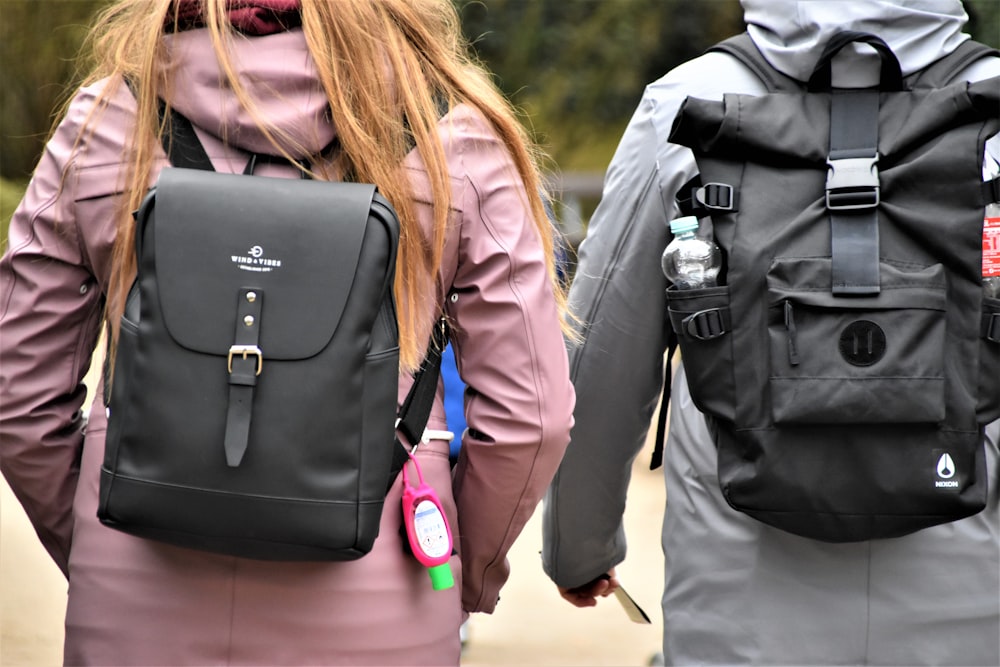 Mujer con chaqueta de cuero negro que lleva una mochila de cuero negro