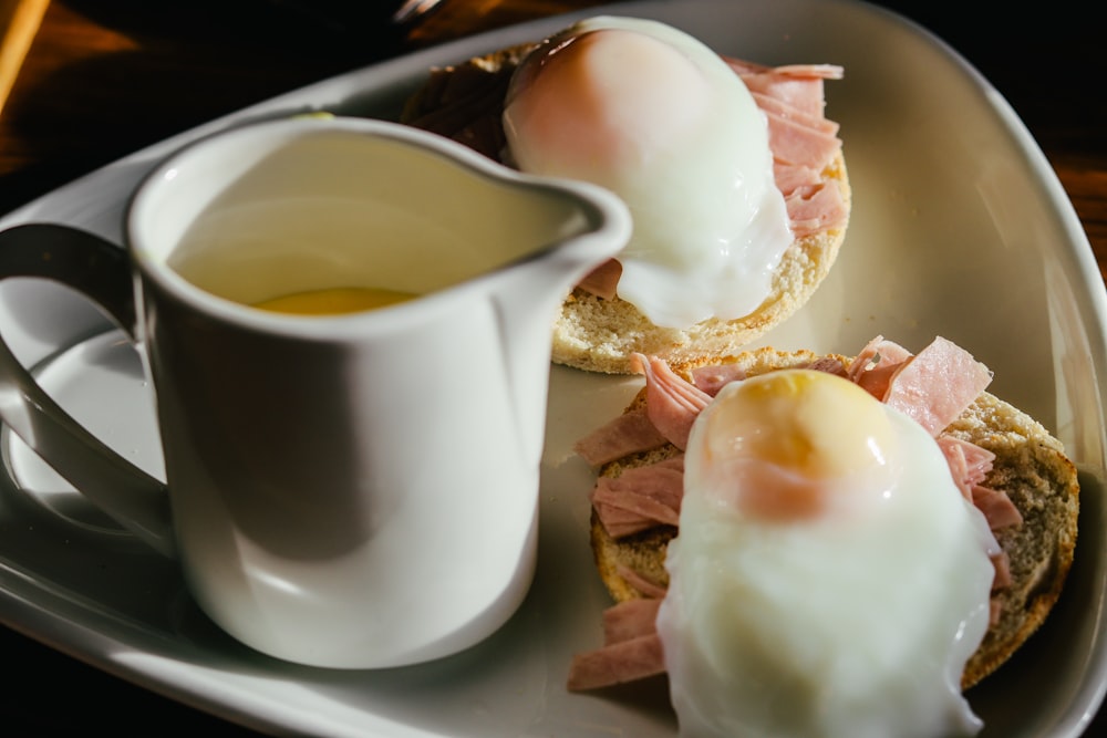 white ceramic mug beside white ceramic plate with food