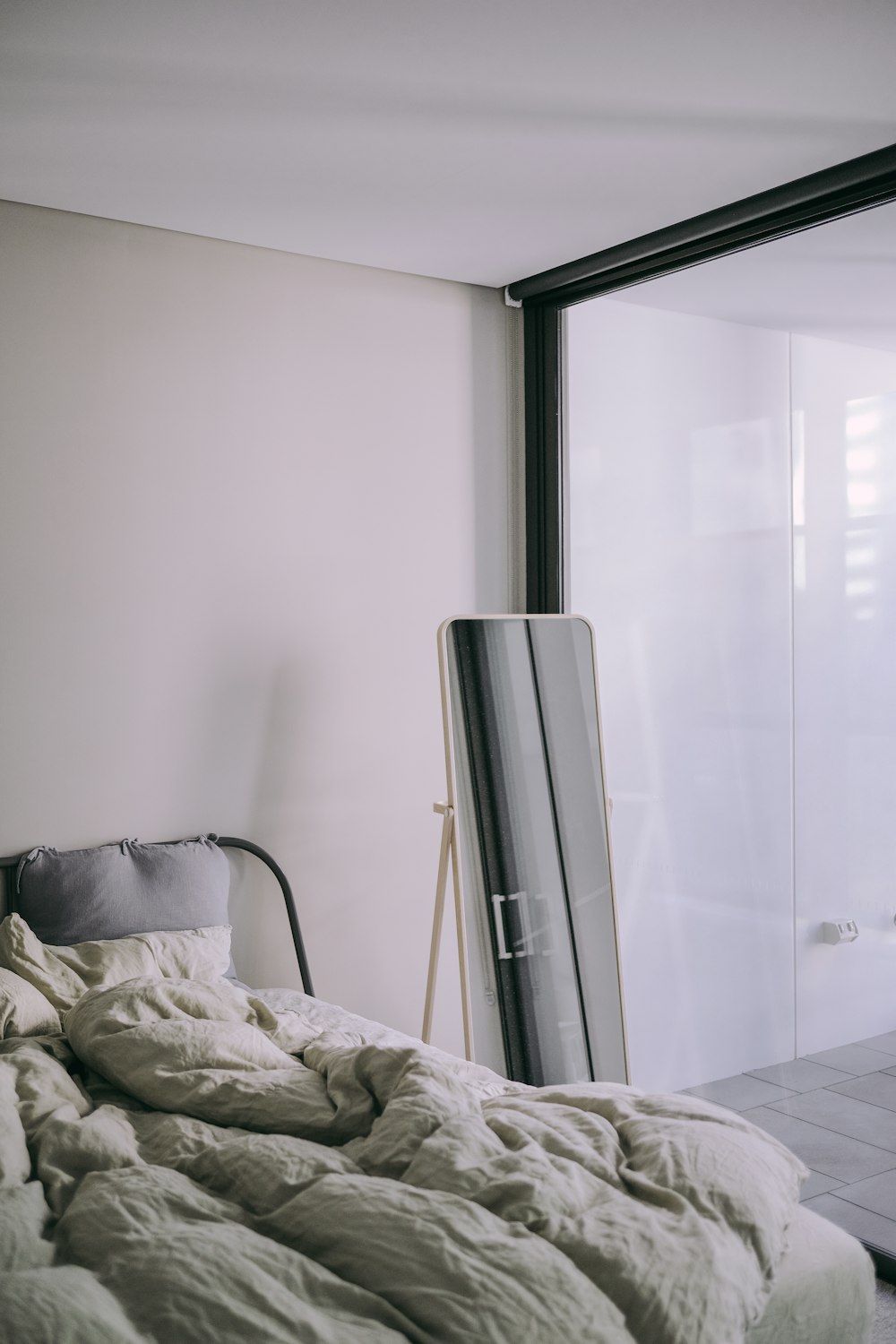 grey and black tower heater beside bed