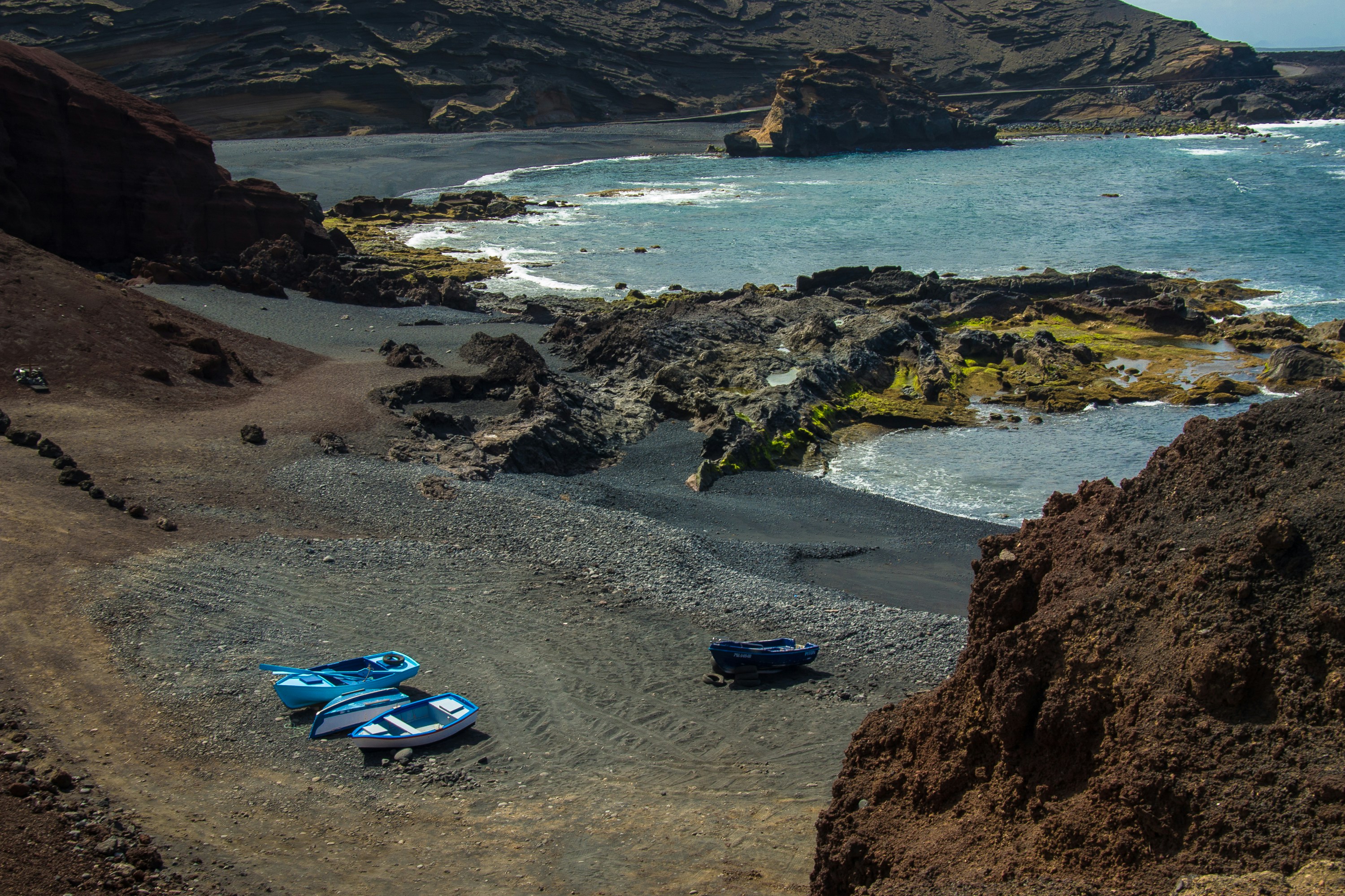 blue and white kayak on beach shore during daytime
