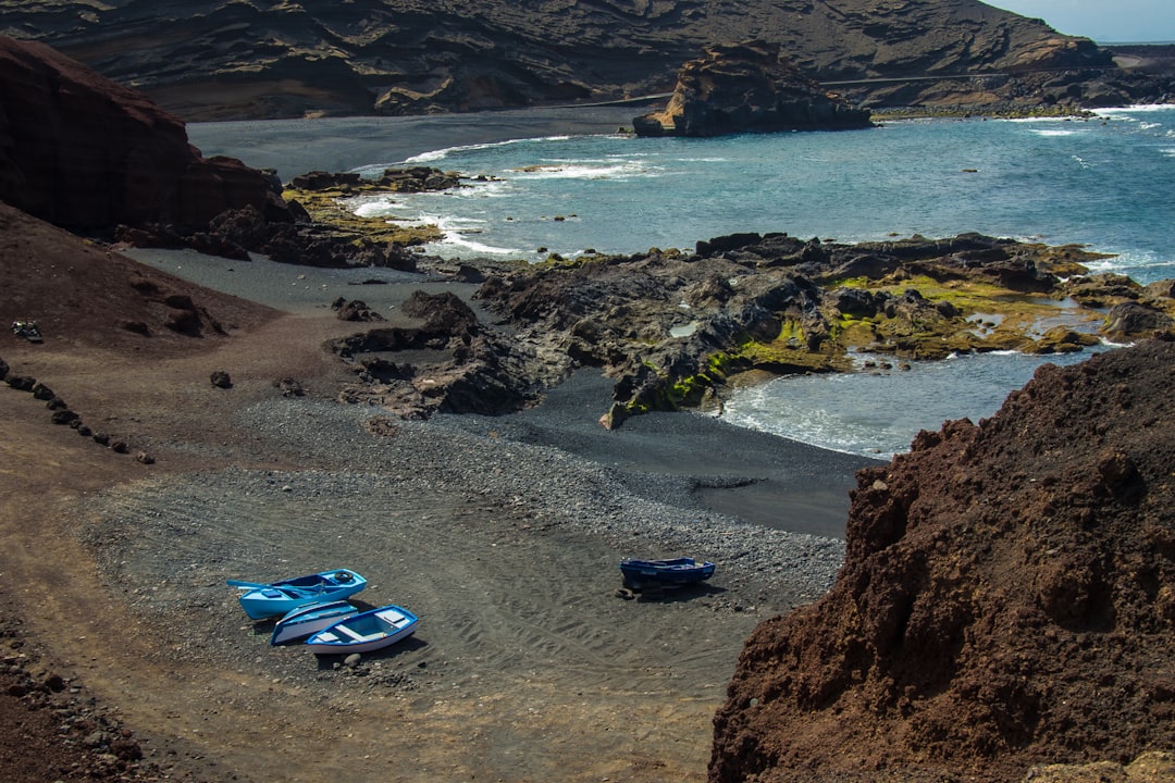 Three rowboat beached on one the the pebbled beaches near El Golfo, Lanzarote