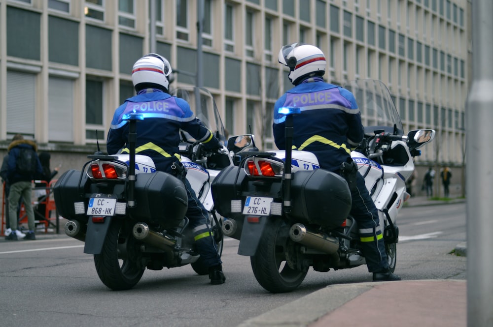 man in blue and black jacket riding on black motorcycle