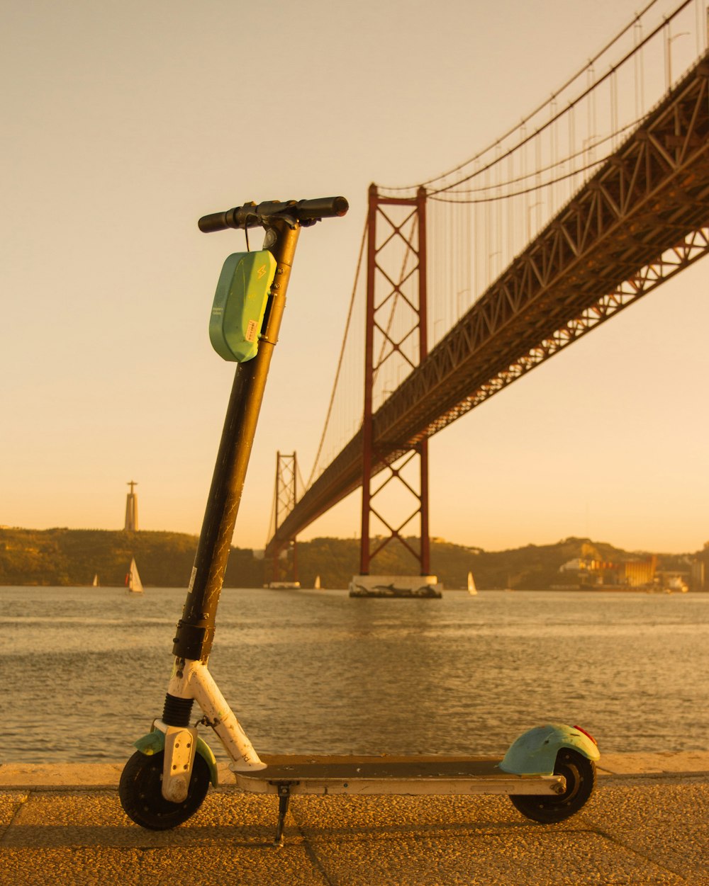 yellow and black metal bridge over body of water during daytime