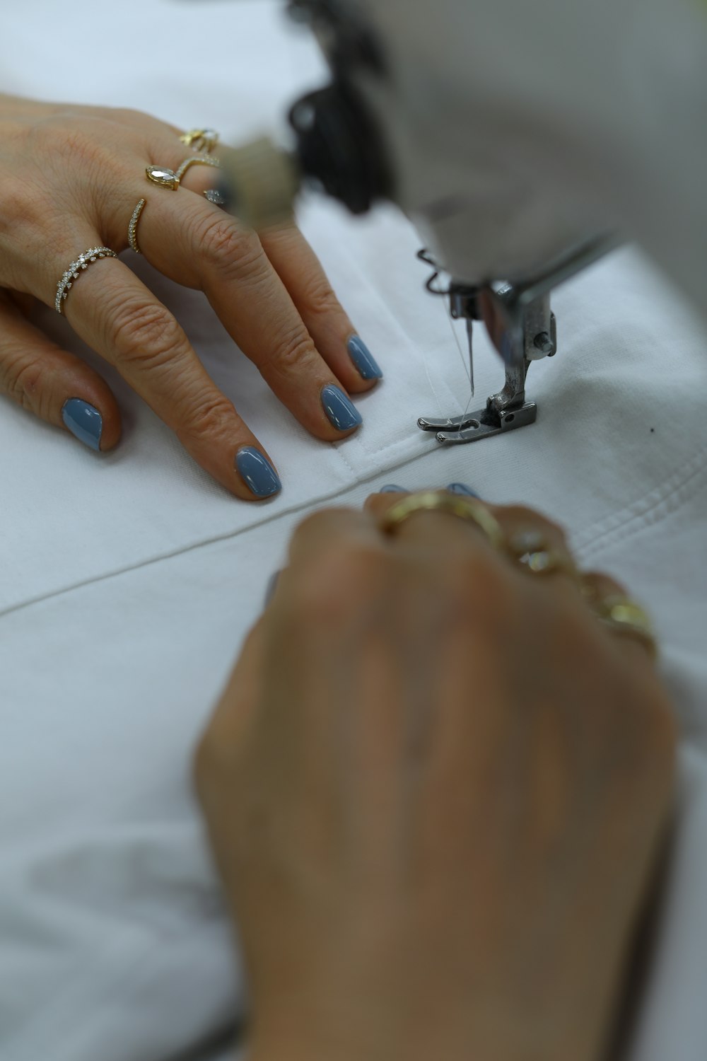 person wearing silver ring and gold ring