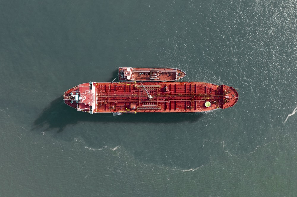 red and white ship on sea