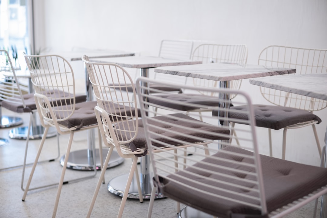 white metal framed glass top table with chairs