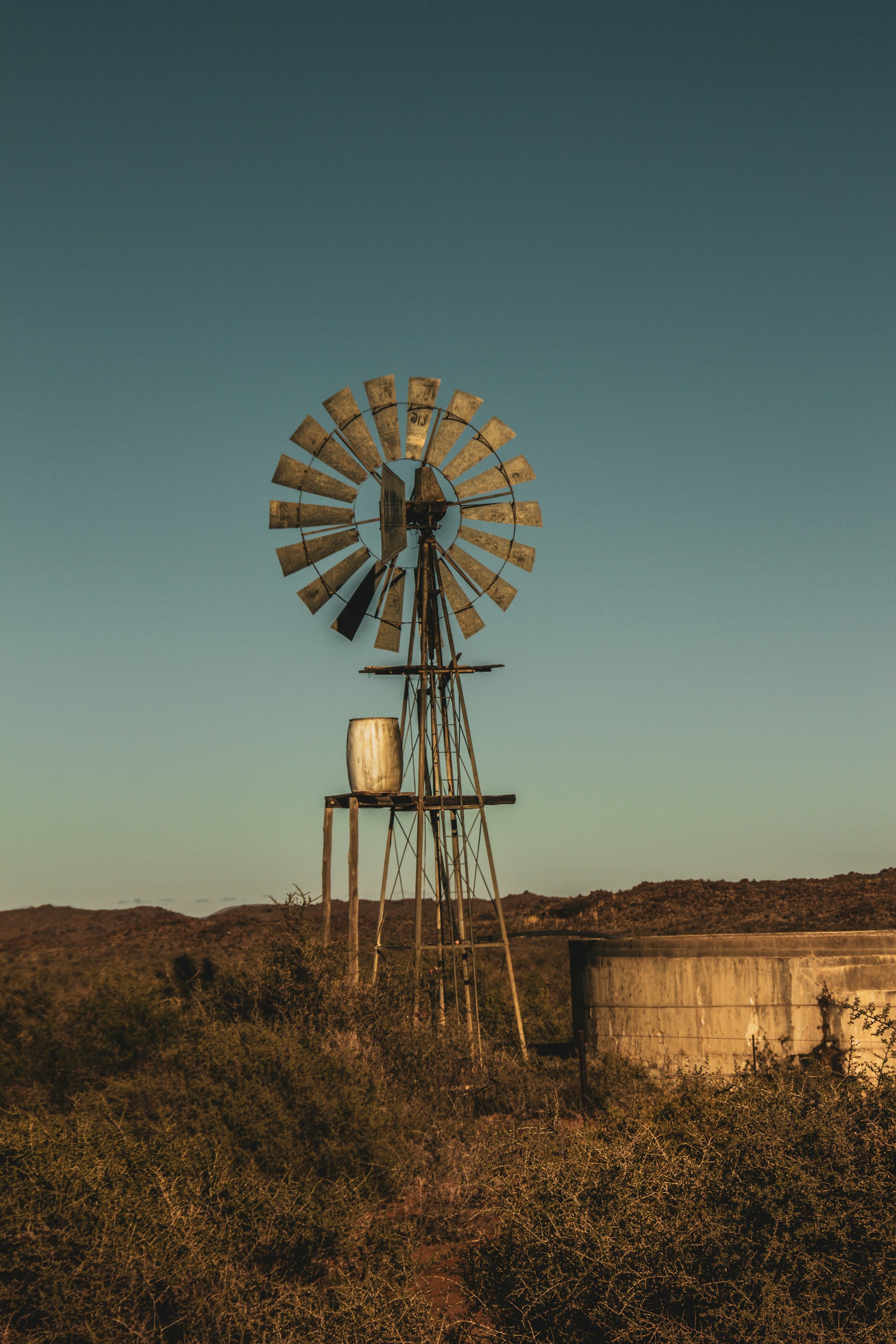 brown and white windmill under blue sky during daytime