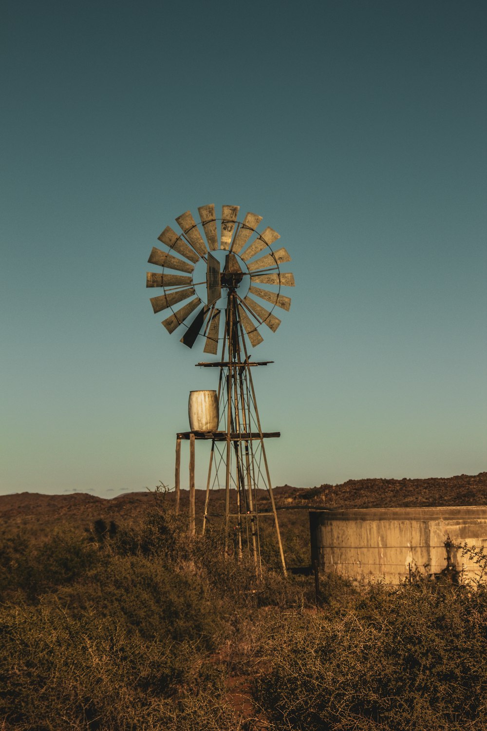 brown and white windmill under blue sky during daytime