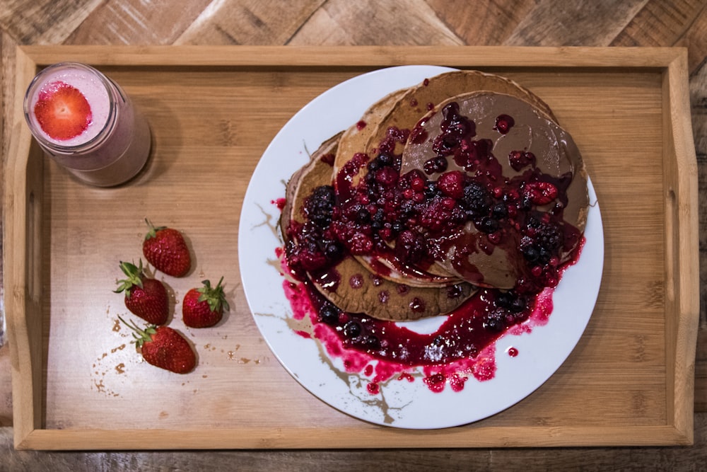 strawberry and blueberry on white ceramic plate