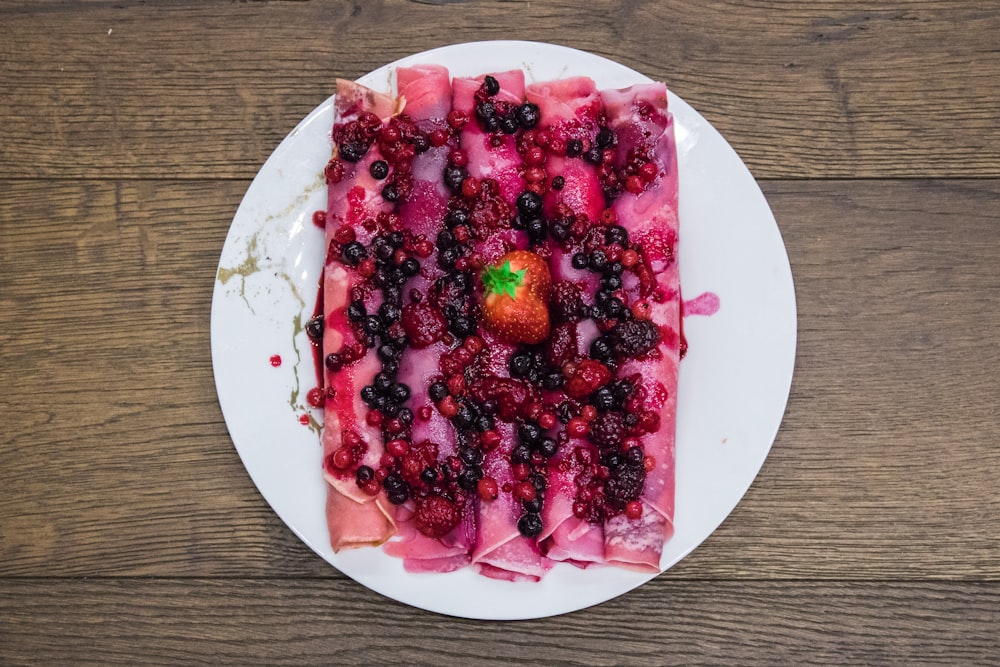 red fruit on white ceramic plate