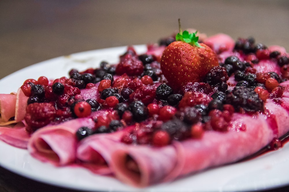 strawberry and blueberry on white ceramic plate