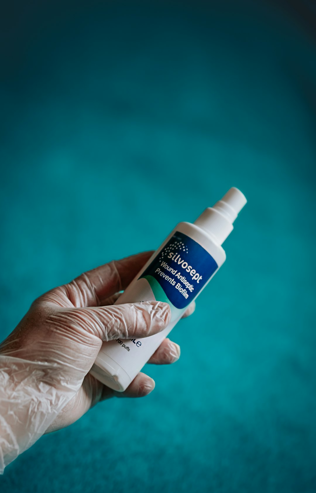 person holding white and blue plastic bottle