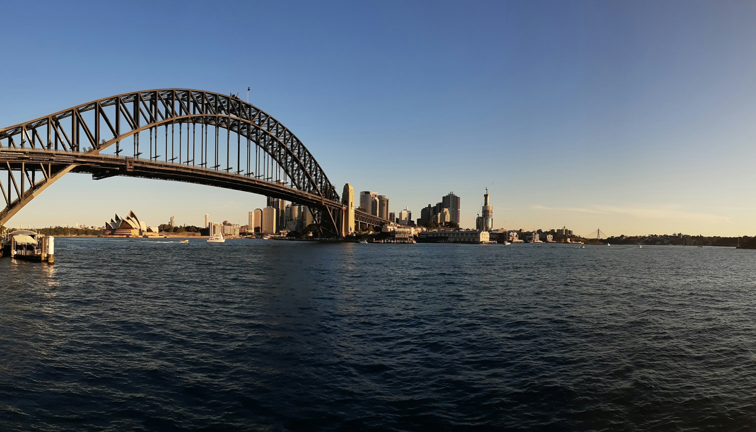 bridge over water near city buildings during daytime