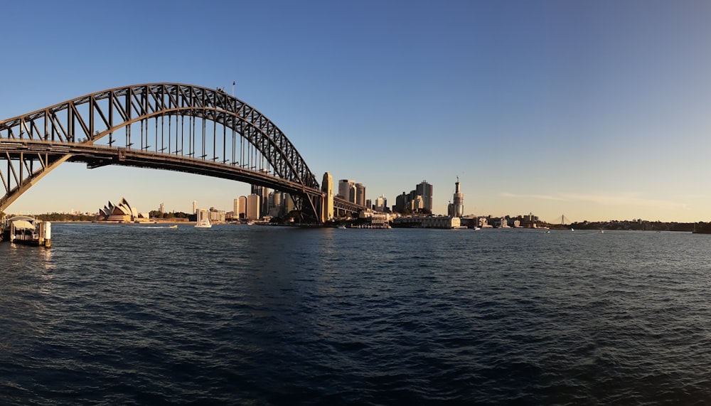 bridge over water near city buildings during daytime