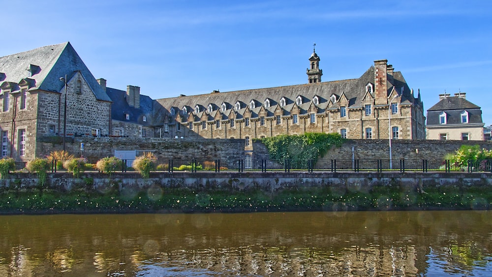 a large building sitting next to a body of water