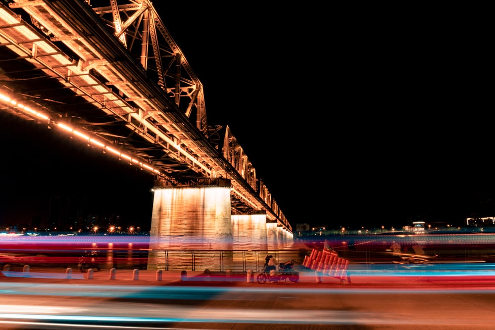 time lapse photography of cars on bridge during night time