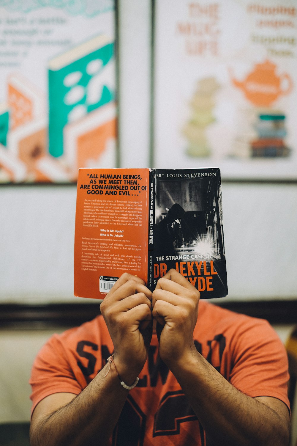 person holding orange and black labeled box