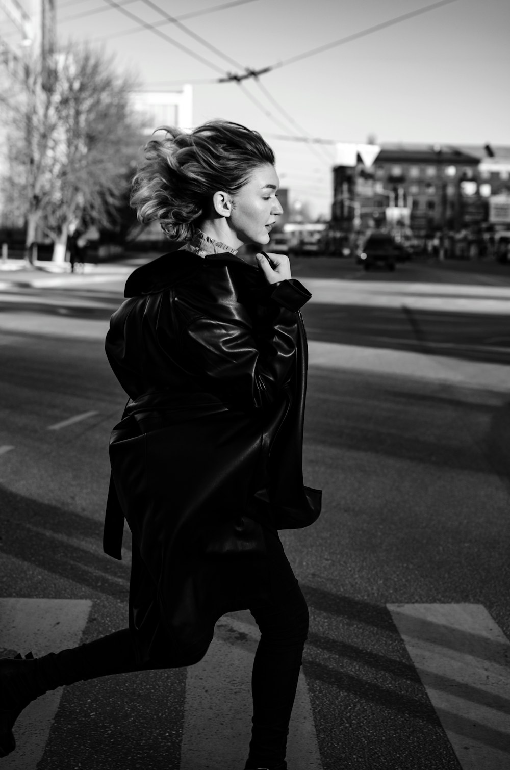 woman in black coat standing on the road