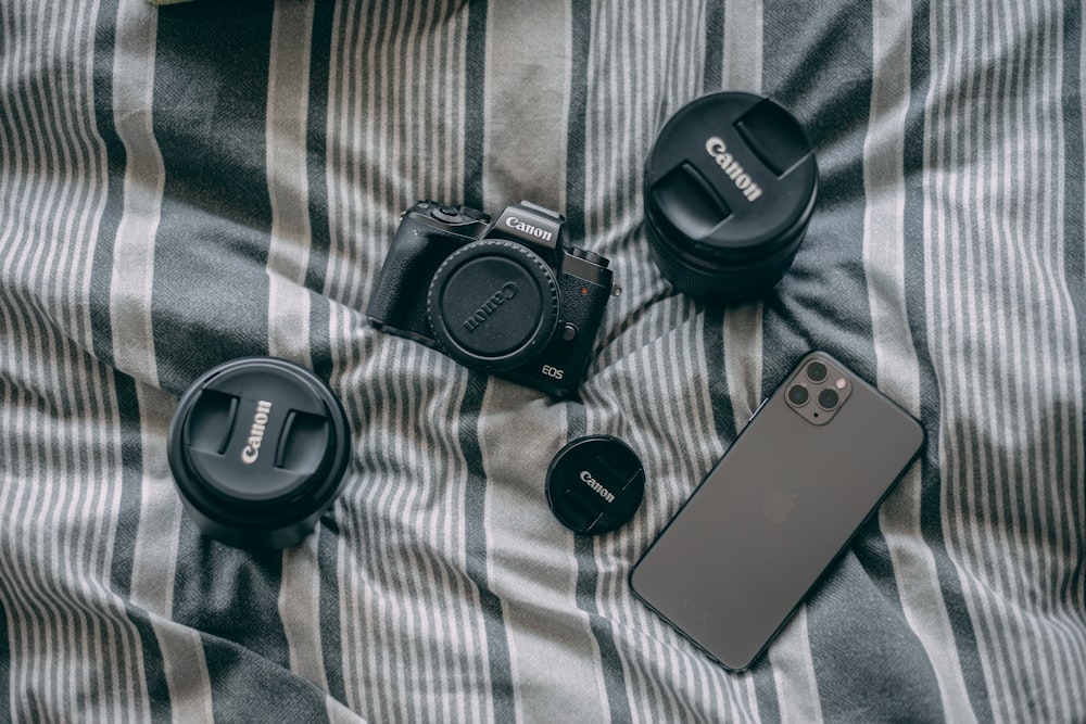 black samsung smartphone beside black samsung camera lens
