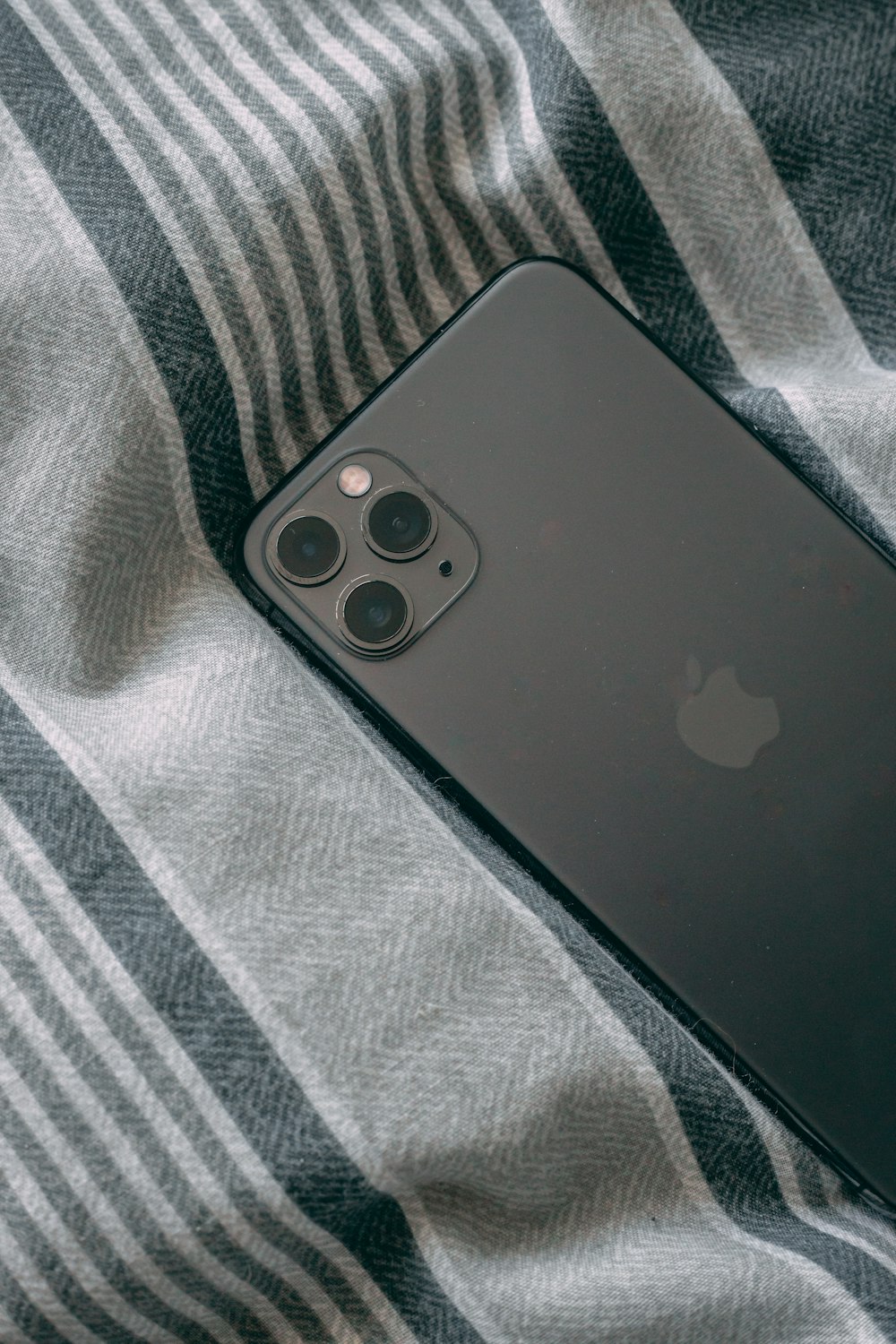 black iphone 7 on gray textile