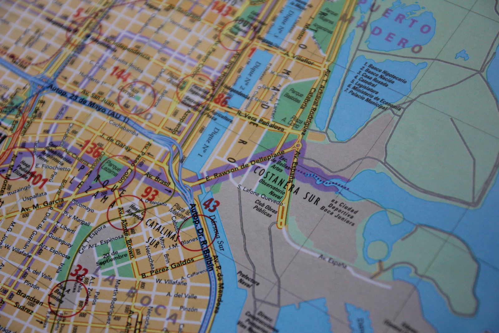 A printed city map, districts and water drawn in different colors