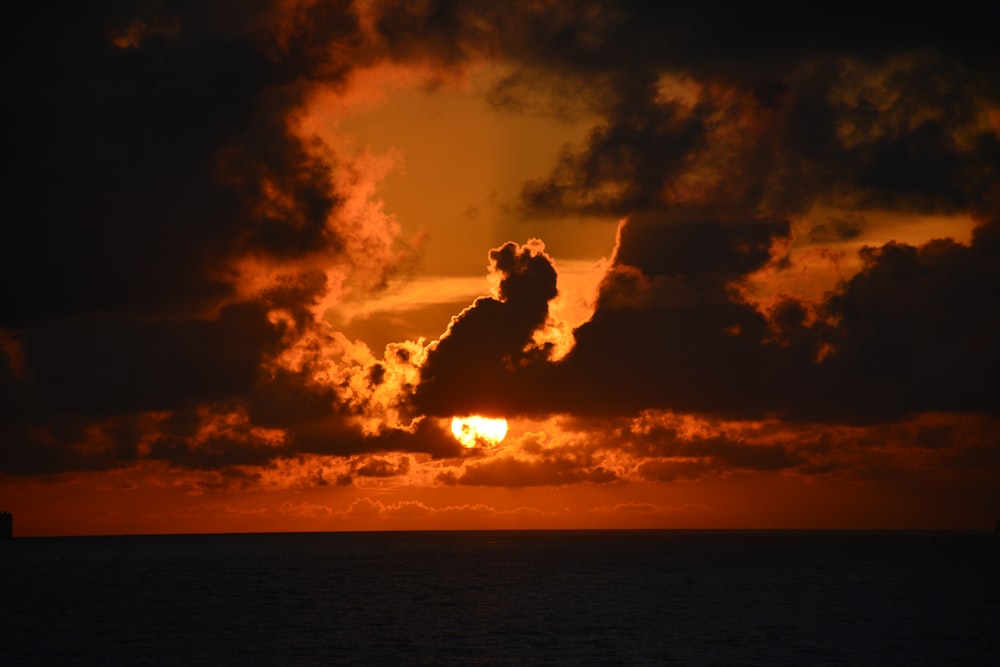 silhouette of man jumping on water during sunset