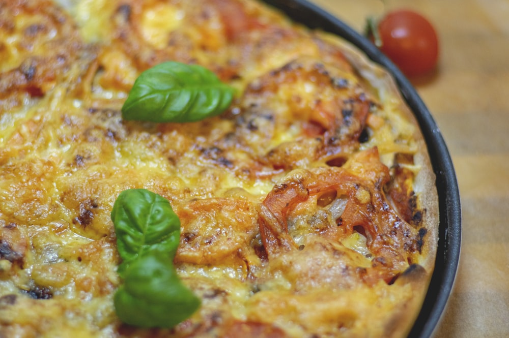 a close up of a pizza on a pan on a table