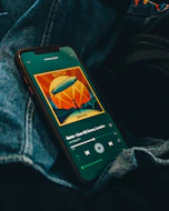 black iphone 5 on blue denim textile