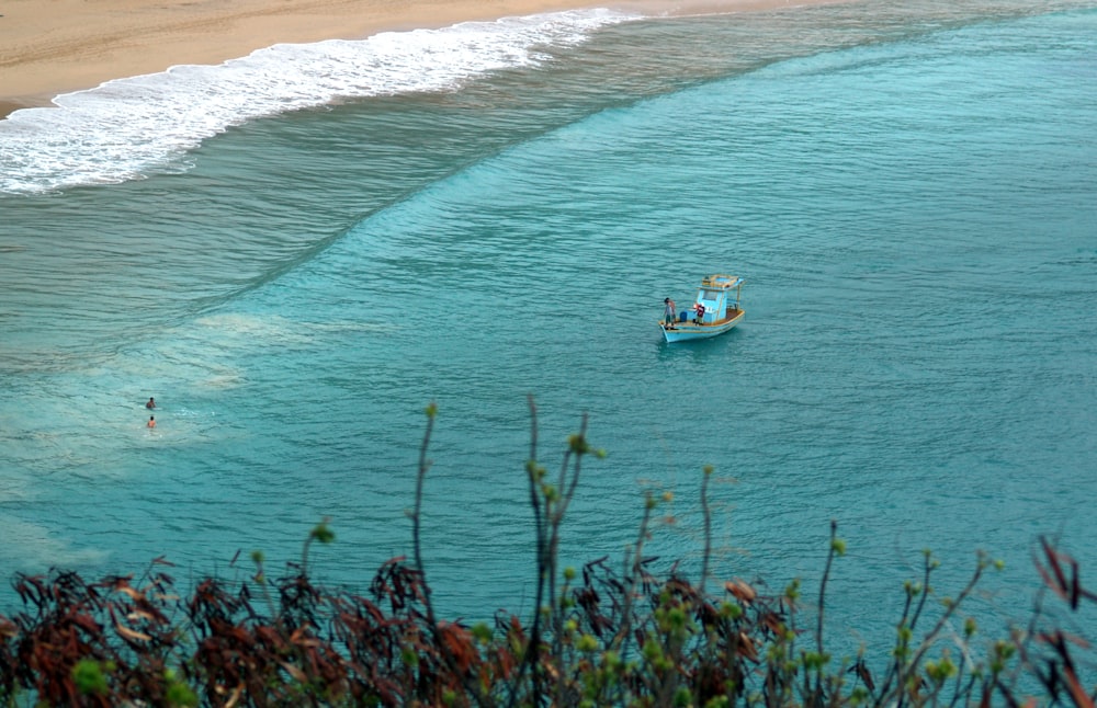 white and blue boat on sea during daytime