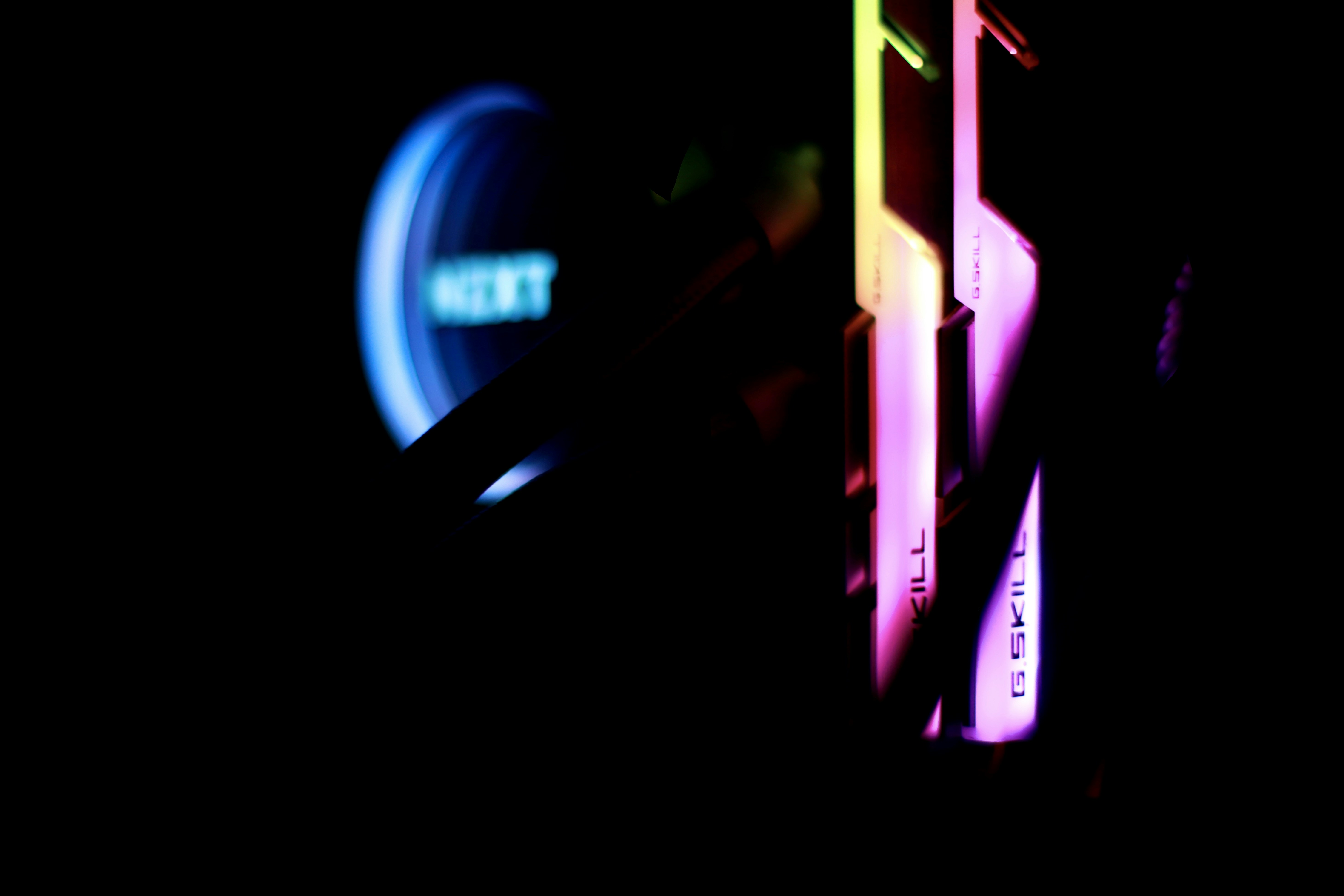 RAM memory sticks with RGB lighting on dark background, deep shadows, cool steel tones