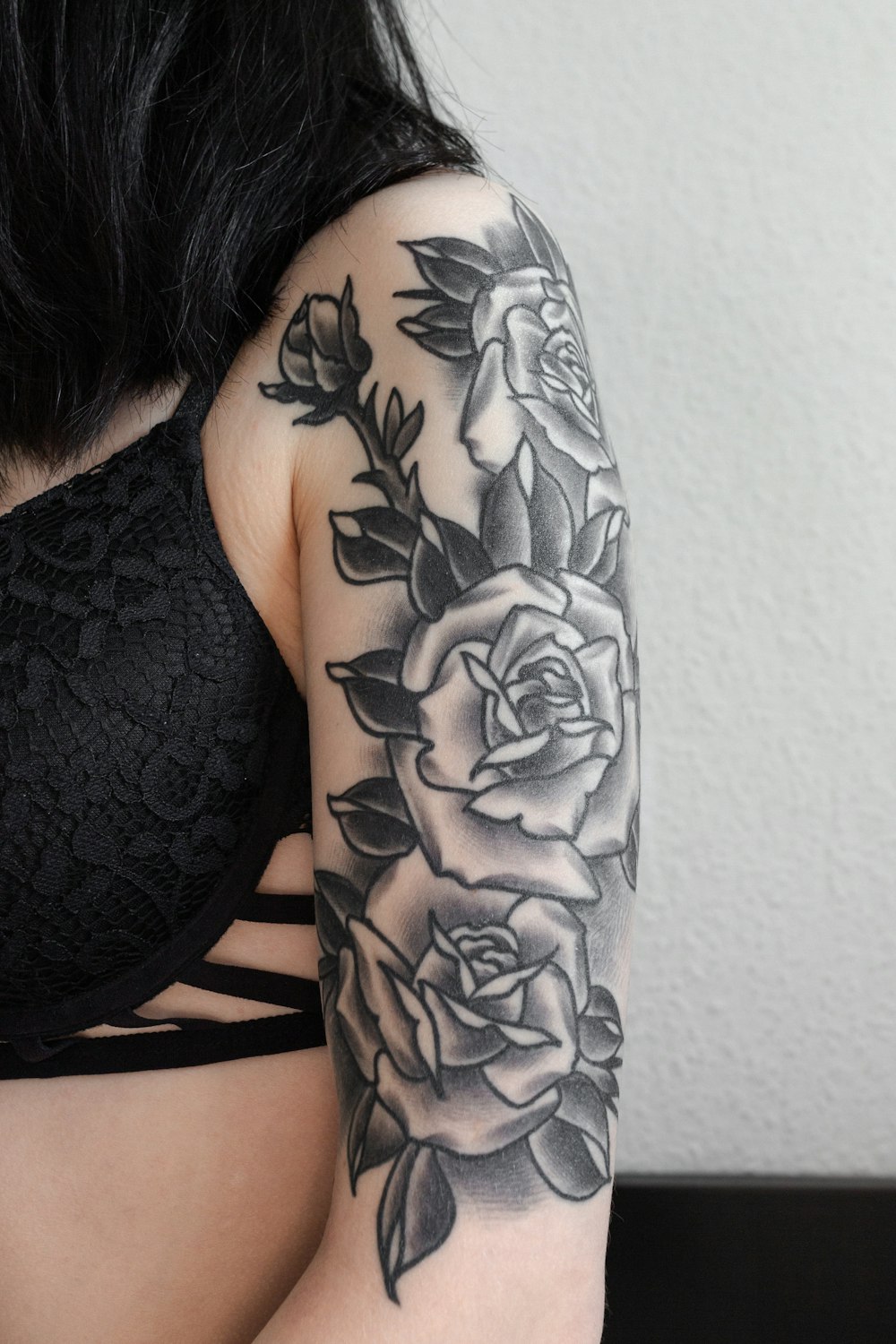 woman with black floral tattoo on her back