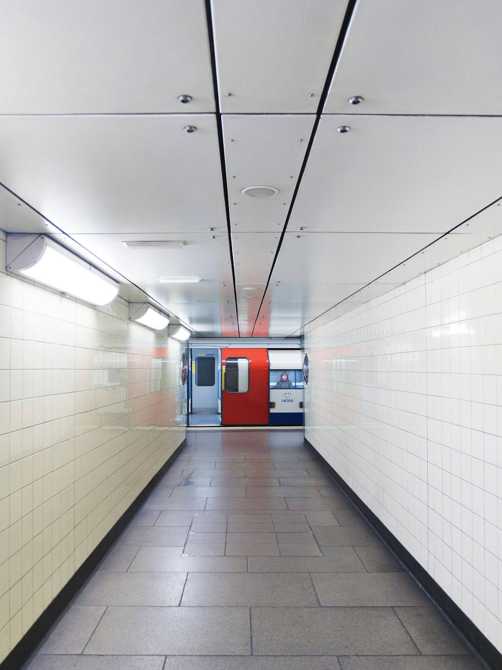 red and white train in tunnel