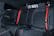Close-up of a sleek black and red car interior showcasing freshly installed seat covers.
