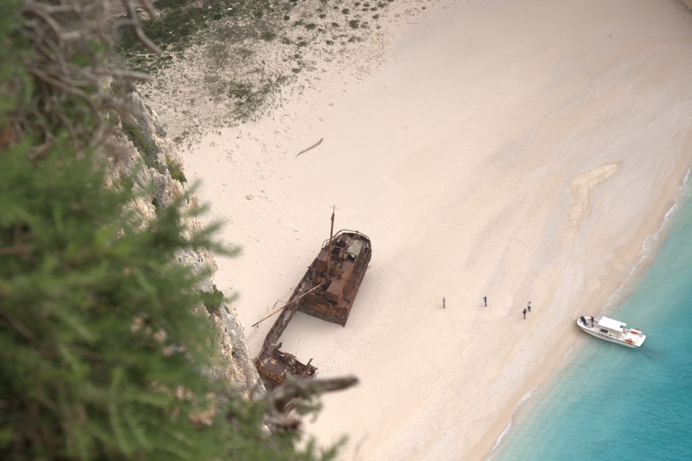 aerial view of brown boat on beach during daytime