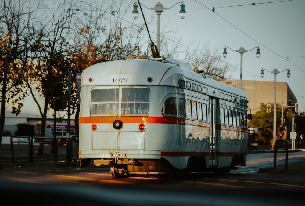 white and blue train on rail tracks