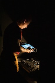 man in red shirt and brown pants holding tablet computer