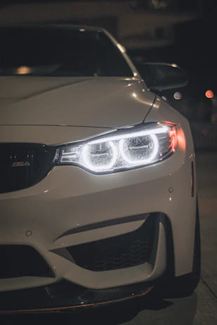 Bright headlights glowing on a sleek car front