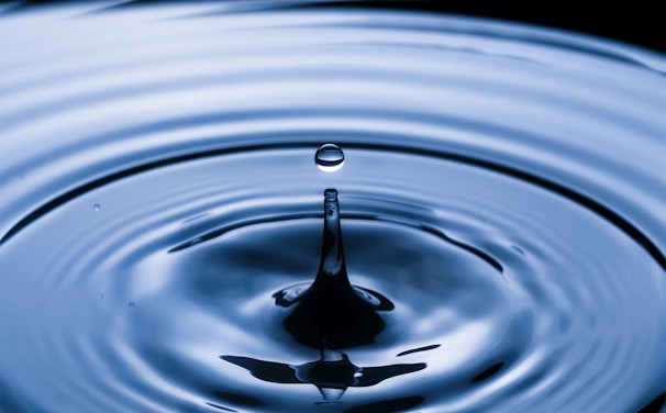 water drop in water in grayscale photography